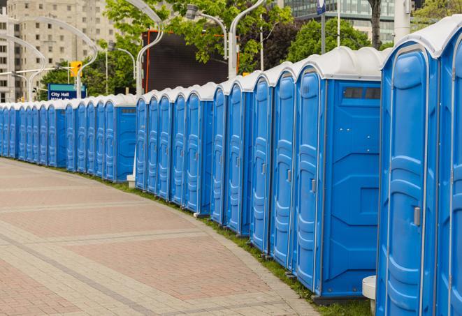 a line of brightly-colored portable restrooms, perfect for outdoor festivals and concerts in Angelus Oaks CA